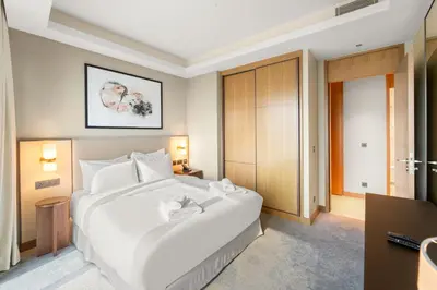 a large white bed in a hotel room at VayK - Exceptional 3BR at Address Dubai Opera in Dubai