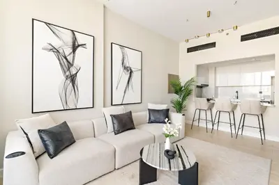 a living room with a white couch and a table at VayK - Luxurious 2BR in JVC in Dubai
