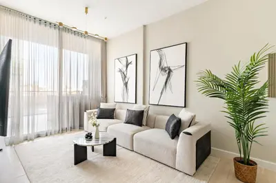 a living room with a couch and a table at VayK - Luxurious 2BR in JVC in Dubai