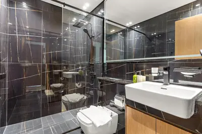 a bathroom with a sink and a toilet and a shower at VayK - Stylish 2BR in JVC with Private Pool in Dubai