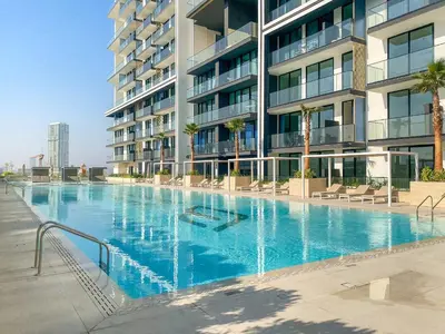 a large swimming pool in front of a building at VayK - Stylish 2BR in JVC with Private Pool in Dubai
