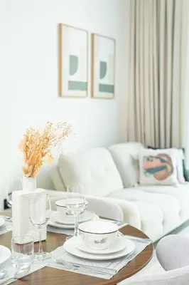 a living room with a table with plates and wine glasses at PVH - Serene 1BR with City View - Binghatti House in Dubai