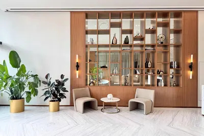 a room with two chairs and a table and a shelf at PVH - Serene 1BR with City View - Binghatti House in Dubai