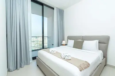 a bedroom with a large bed and a large window at PVH - Cozy 1BR with City View - Binghatti House in Dubai