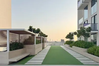 a balcony of a building with a green lawn at PVH - Cozy 1BR with City View - Binghatti House in Dubai