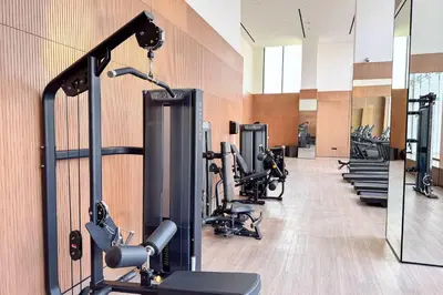 a gym with treadmills and exercise equipment in a building at PVH - Cozy 1BR with City View - Binghatti House in Dubai