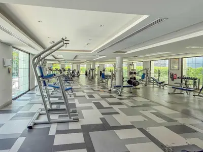 a gym with treadmills and machines in a building at Frank Porter - Hilliana Tower in Dubai