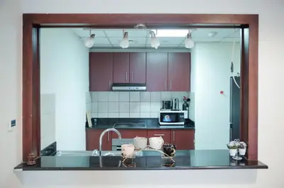 a kitchen with a sink and a mirror at 1 Bedroom Apartment at Marina with Stunning View in Dubai