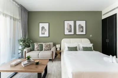 a living room with two beds and a couch at HAVN - Studio in Alka, The Greens in Dubai