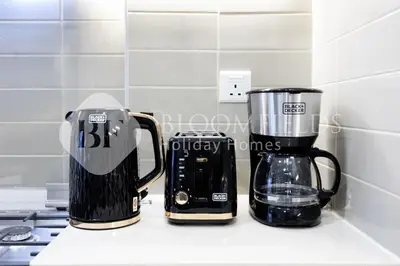two coffee makers sitting on a counter in a kitchen at Bloomfields Cozy 1br Apt Town Square in Dubai
