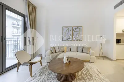 a living room with a couch and a table at Bloomfields Cozy 1br Apt Town Square in Dubai