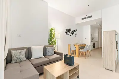 a living room with a couch and a table at FIRST CLASS Studio Marquise Bliss in Dubai