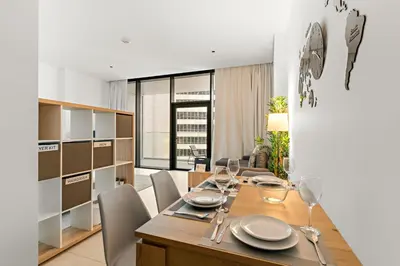a dining room with a wooden table and chairs at FIRST CLASS Studio Marquise Bliss in Dubai