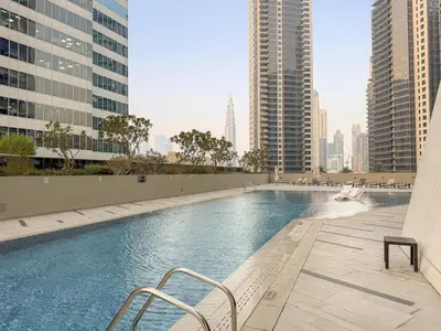 a swimming pool in the middle of a city with tall buildings at FIRST CLASS Studio Marquise Bliss in Dubai