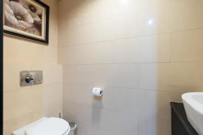 a bathroom with a toilet and a sink at Comfortable - Vibrant - Convenient in Dubai