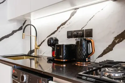 a coffee maker sitting on top of a kitchen counter at Luxury Studio with Private Jacuzzi &Canal View in Dubai