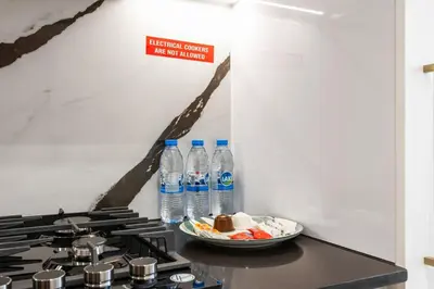 a counter with bottles of water and a bowl of food at Luxury Studio with Private Jacuzzi &Canal View in Dubai