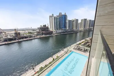 a view of a river from a building with a pool at Luxury Studio with Private Jacuzzi &Canal View in Dubai