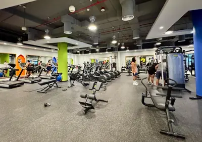 a gym with rows of exercise bikes and people in it at Cozy 3 Bedroom with walking access to JBR Beach in Dubai