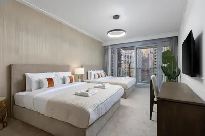 a hotel room with two beds and a television at Luxury 1st Row Burj Khalifa and Fountain Views, Walk to Dubai Mall in Dubai
