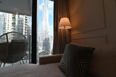 a bedroom with a bed and a large window with a view at Luxury 1st Row Burj Khalifa and Fountain Views, Walk to Dubai Mall in Dubai