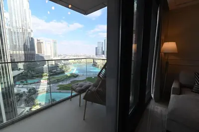 a room with a balcony with a view of the city at Luxury 1st Row Burj Khalifa and Fountain Views, Walk to Dubai Mall in Dubai