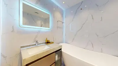 a white bathroom with a sink and a mirror at Locations l Upgraded 1 Bedroom l Marina Views l Free Pool Access in Dubai