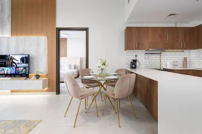 a kitchen with a table and chairs in a room at Elegant JVC 1-Bed with Upgraded Interiors in Dubai