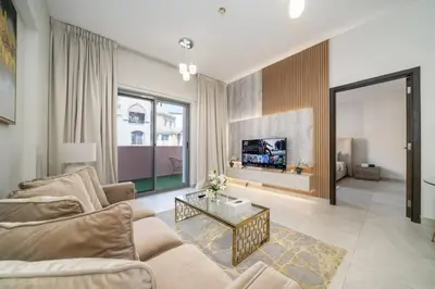 a living room with a couch and a tv at Elegant JVC 1-Bed with Upgraded Interiors in Dubai