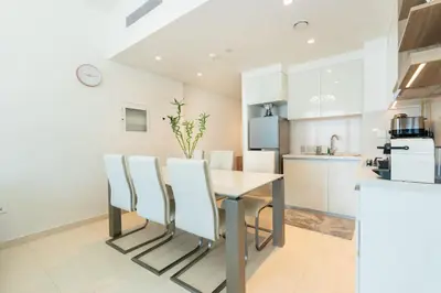 a kitchen and dining room with a table and chairs at CitiHome Luxury 1BR - Downtown Views 2 High Floor in Dubai