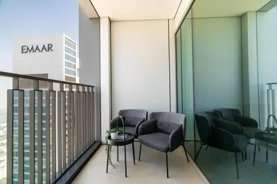 a balcony with chairs and a table and a building at CitiHome Luxury 1BR - Downtown Views 2 High Floor in Dubai