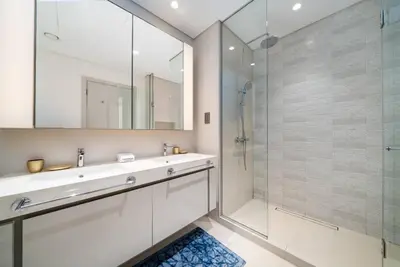 a bathroom with a sink and a shower at Elegant 2 Bed Beach Front Retreat in Dubai