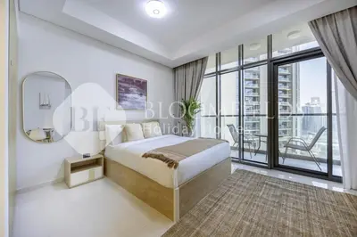 a bedroom with a bed and a large window at Bloomfields Magnificent STU Aykon City in Dubai