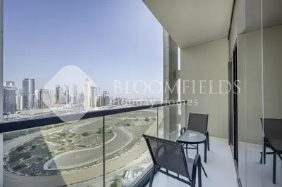 a room with a balcony with a view of the city at Bloomfields Magnificent STU Aykon City in Dubai
