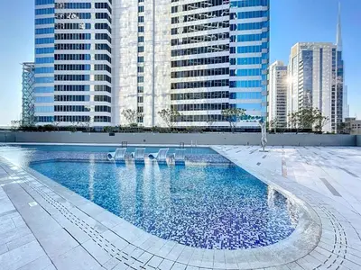 a swimming pool in a city with tall buildings at Luxury Studio at Marquise Square with Burj Khalifa View in Dubai