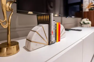 a counter with books and a lamp on a table at Luxury Studio at Marquise Square with Burj Khalifa View in Dubai