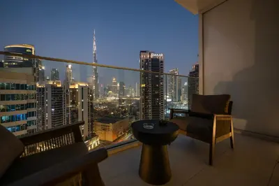a room with a balcony with a view of a city at Luxury Studio at Marquise Square with Burj Khalifa View in Dubai
