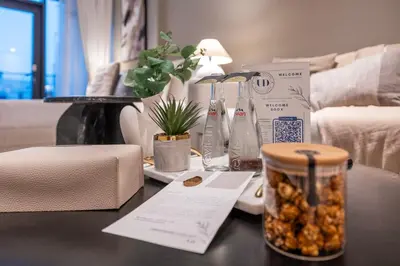 a table with a jar of nuts on a table at Luxury Studio at Marquise Square with Burj Khalifa View in Dubai