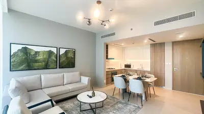 a living room with a couch and a table at Waterfront 1BR, Full Marina View & Pool Access - 34AB04 in Dubai