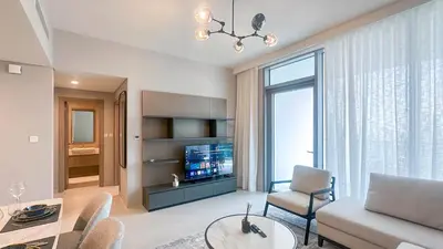 a living room with a couch and a table at Waterfront 1BR, Full Marina View & Pool Access - 34AB04 in Dubai