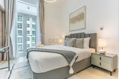 a bedroom with a large bed and a window at Stylish 2BR Stay Near Marina Beach and Ain Dubai, Steps from Shops and Restaurants, Studio One, Dubai Marina by Deluxe Holiday Homes in Dubai