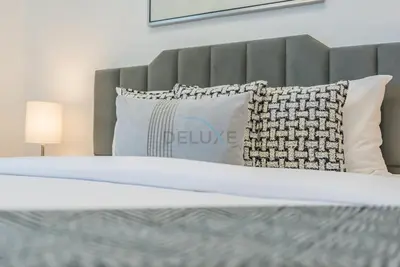 a bedroom with a bed with a pillow and a bed sidx sidx sidx at Stylish 2BR Stay Near Marina Beach and Ain Dubai, Steps from Shops and Restaurants, Studio One, Dubai Marina by Deluxe Holiday Homes in Dubai