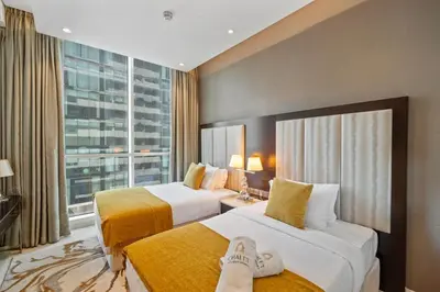 a hotel room with two beds and a large window at Luxe 2 Bedroom Near Dubai Mall DAMAC Uppercrest Downtown - Free Parking in Dubai