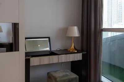 a room with a desk with a laptop and a window at Luxe 2 Bedroom Near Dubai Mall DAMAC Uppercrest Downtown - Free Parking in Dubai