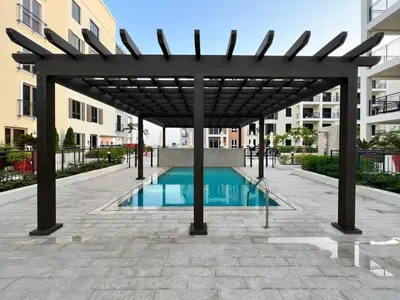 a pergola over a swimming pool in a building at GuestReady - Chic coastal living at Port de La Mer in Dubai