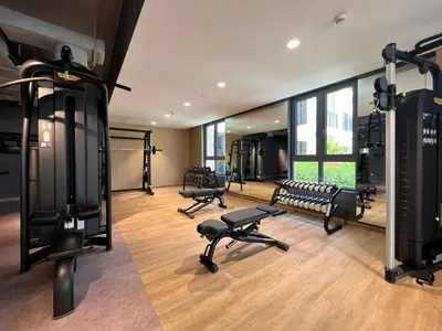 a gym with treadmills and benches in a room at GuestReady - Chic coastal living at Port de La Mer in Dubai