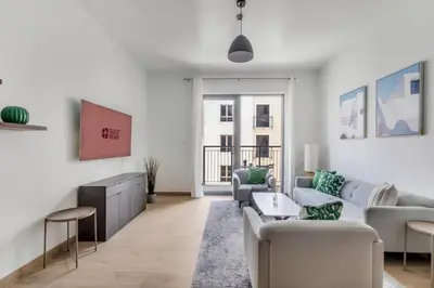 a living room with a couch and chairs at GuestReady - Chic coastal living at Port de La Mer in Dubai