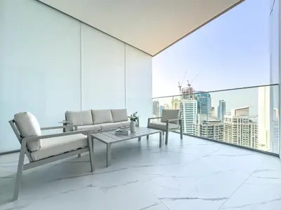 a living room with white furniture and a large window at Liv Marina Panoramic 3BR with Palm & Sea View in Dubai