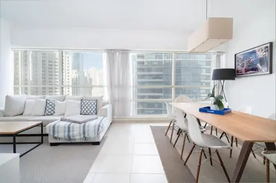 a living room with a couch and a table at Exquisite 2BR Apartment in Dubai Marina in Dubai