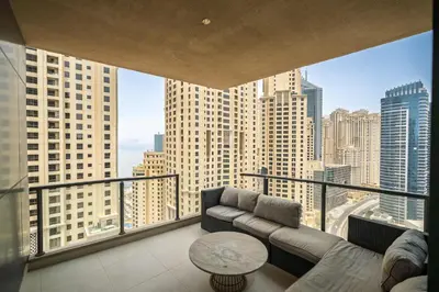 a living room with a couch and a view of a city at Exquisite 2BR Apartment in Dubai Marina in Dubai
